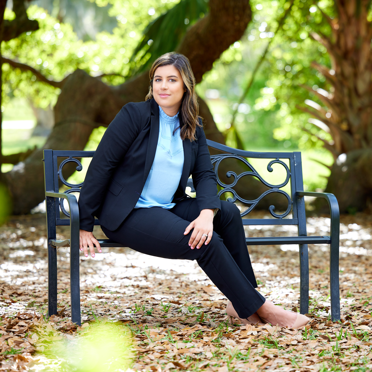 Carmen Liriano - Personal Injury Attorney at Law sitting on Park Bench
